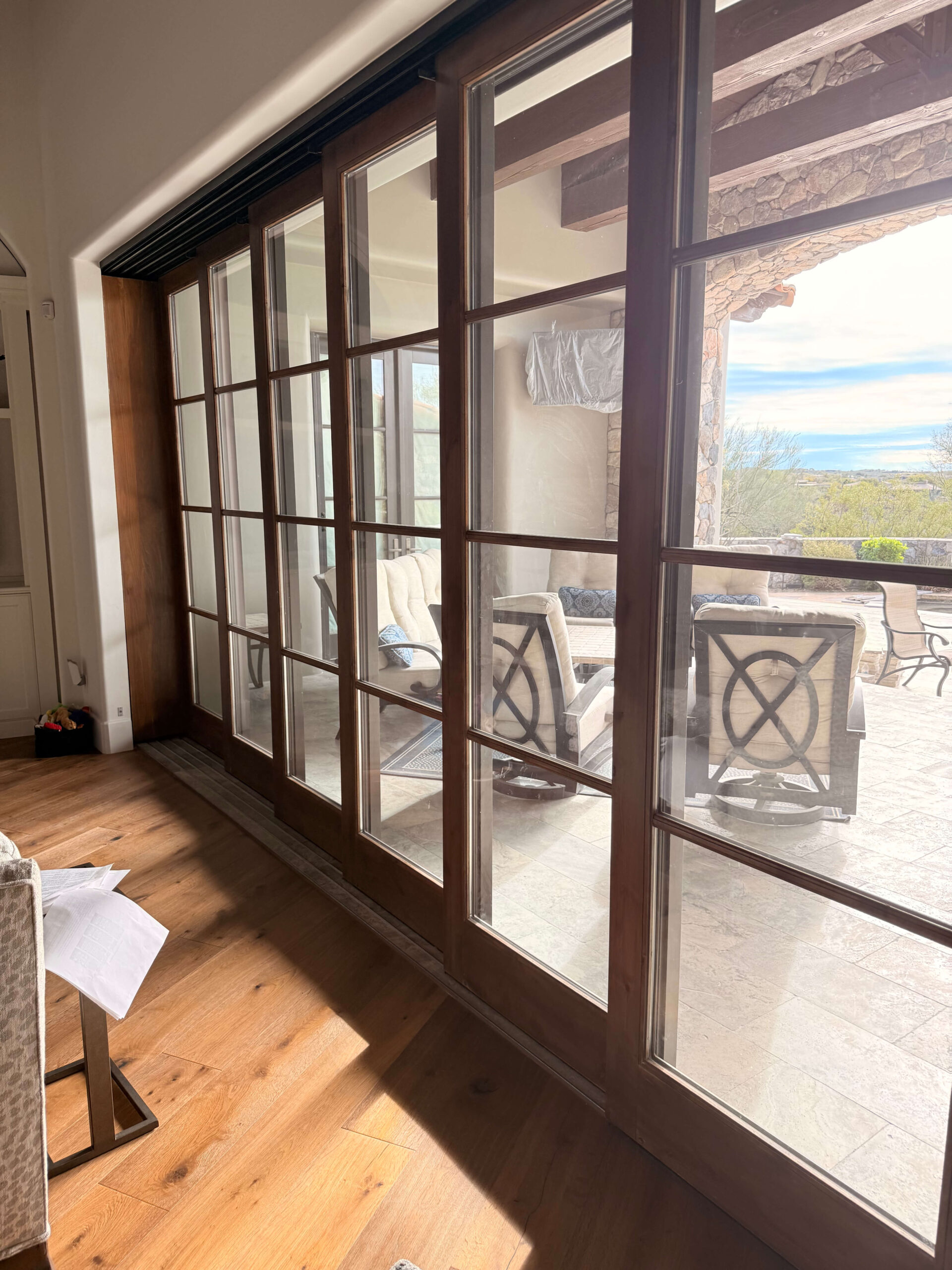 Sliding glass doors opening to an outdoor patio with furniture